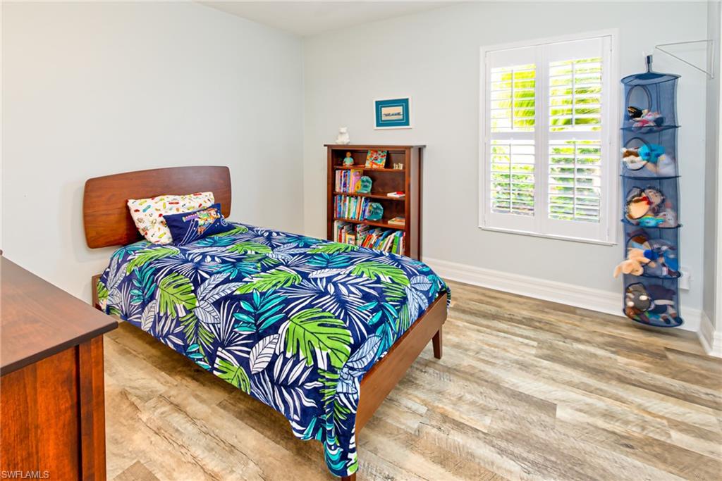 1638 Triangle Palm Terrace Naples, FL 34119 - Photo 14 of 30 a bedroom with a bed and a window