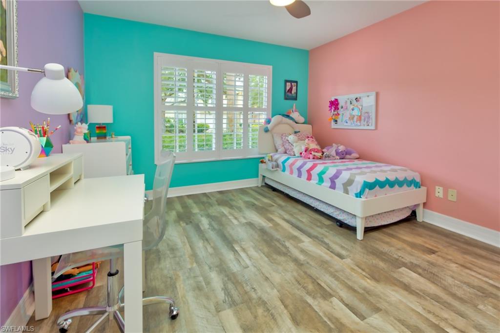 1638 Triangle Palm Terrace Naples, FL 34119 - Photo 15 of 30 a bedroom with a bed and a window