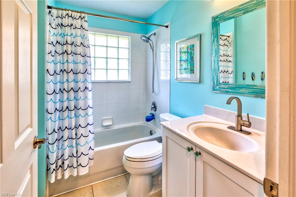 1638 Triangle Palm Terrace Naples, FL 34119 - Photo 16 of 30 a bathroom with a sink toilet and shower