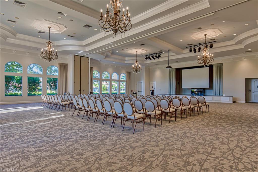 1638 Triangle Palm Terrace Naples, FL 34119 - Photo 20 of 30 a large room with lots of furniture and a chandelier