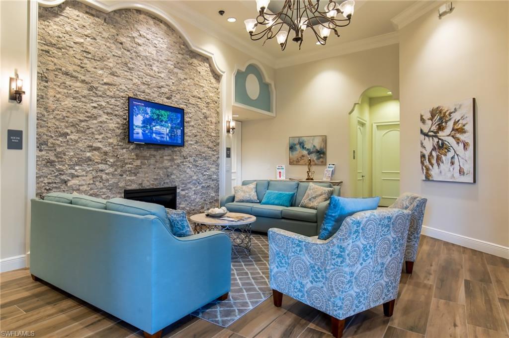 1638 Triangle Palm Terrace Naples, FL 34119 - Photo 21 of 30 a living room with furniture and a fireplace