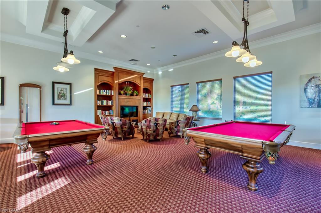 1638 Triangle Palm Terrace Naples, FL 34119 - Photo 24 of 30 a living room with furniture a rug and a chandelier