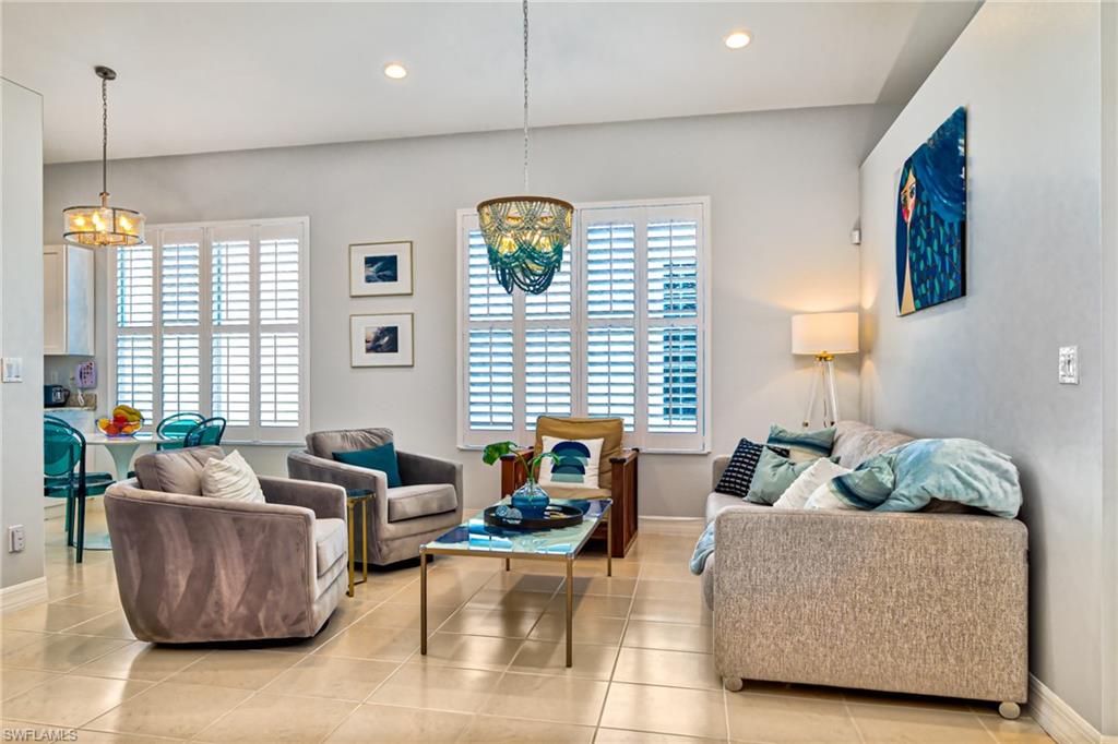1638 Triangle Palm Terrace Naples, FL 34119 - Photo 4 of 30 a living room with furniture and a large window