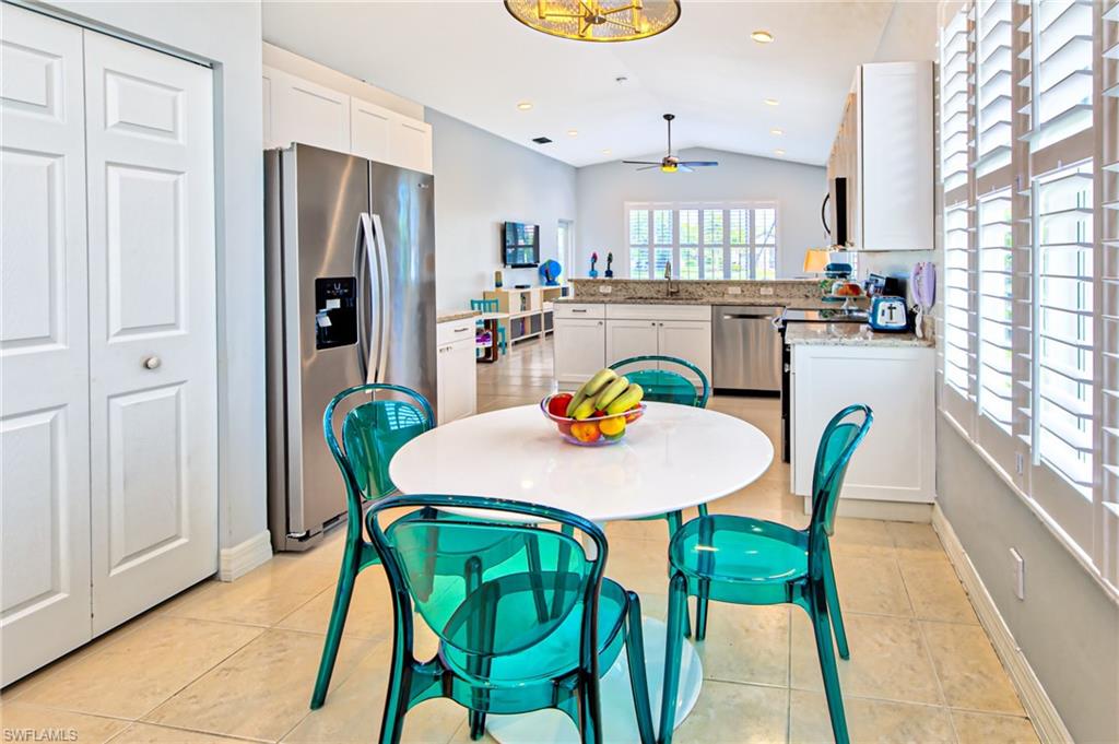 1638 Triangle Palm Terrace Naples, FL 34119 - Photo 5 of 30 a view of a dining room with furniture and a window