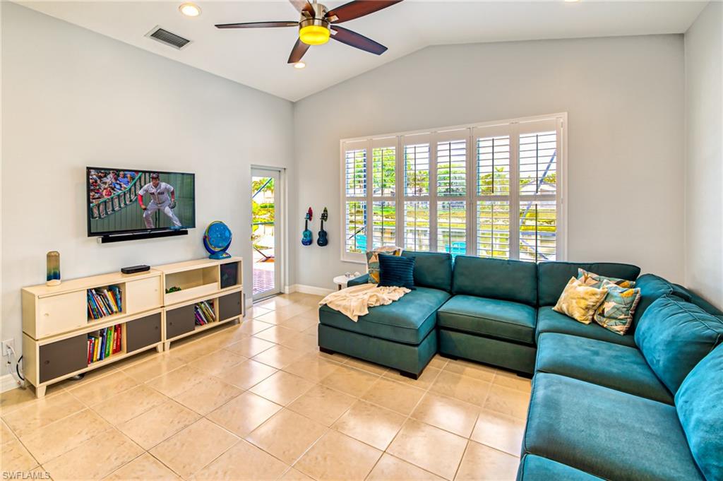 1638 Triangle Palm Terrace Naples, FL 34119 - Photo 7 of 30 a living room with furniture and a flat screen tv