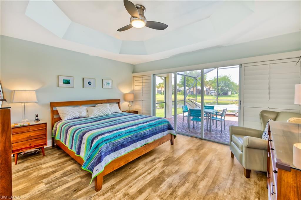 1638 Triangle Palm Terrace Naples, FL 34119 - Photo 10 of 30 a bedroom with a bed and a view of living room