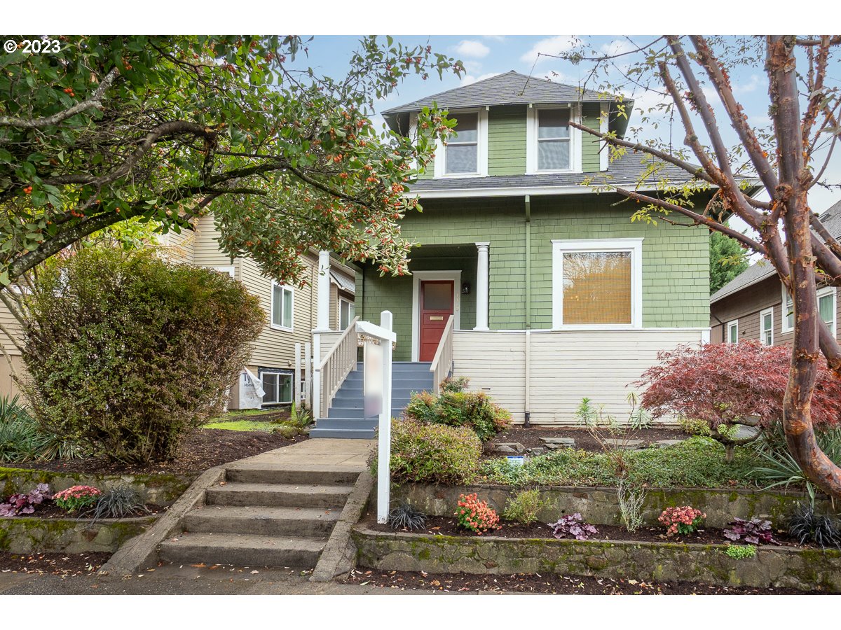 1410 Southeast 35th Avenue Portland, OR 97214 - Photo 1 of 39 a view of a white house next to a yard with big trees