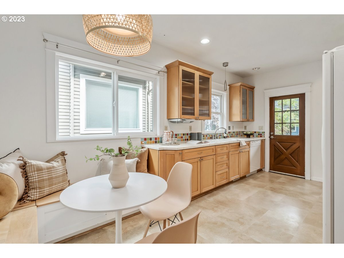 1410 Southeast 35th Avenue Portland, OR 97214 - Photo 11 of 39 a large white kitchen with a sink and breakfast area