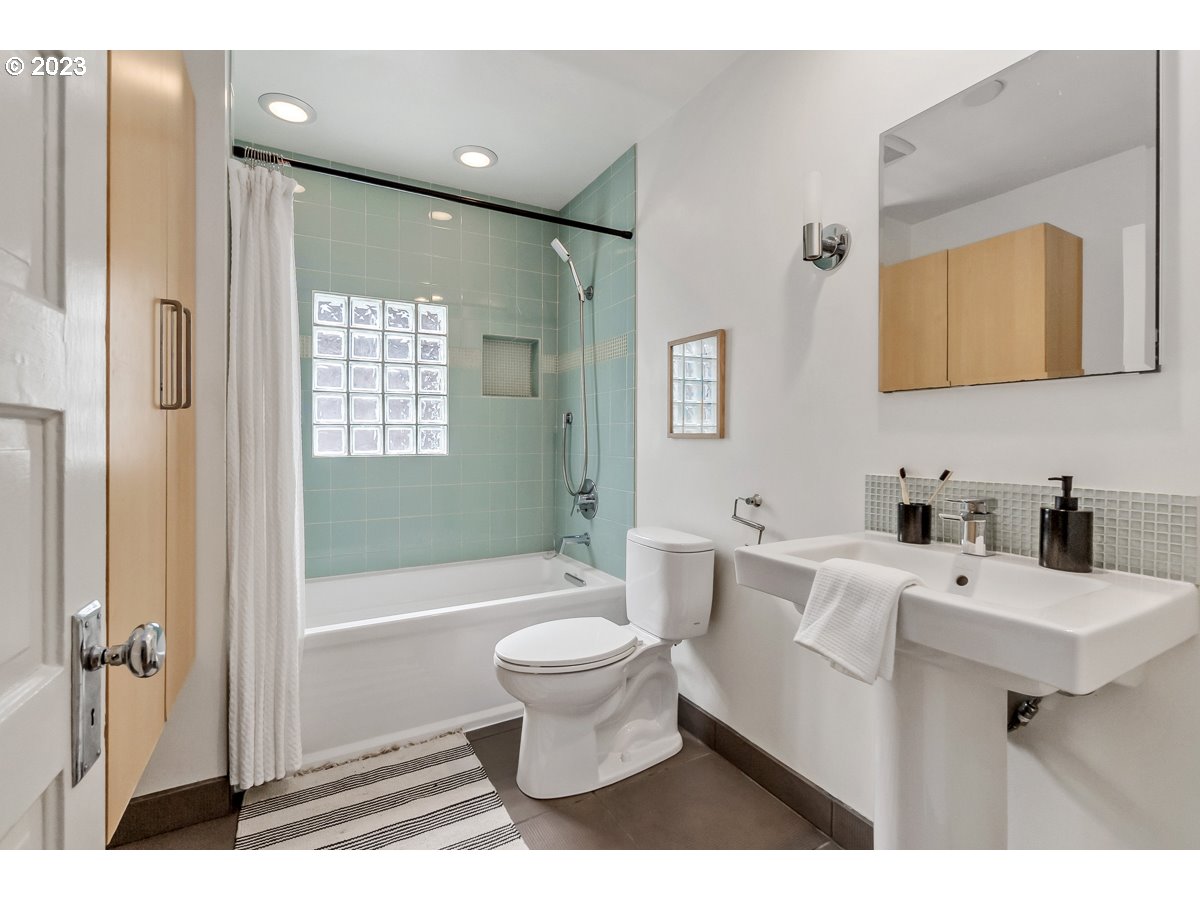 1410 Southeast 35th Avenue Portland, OR 97214 - Photo 17 of 39 a bathroom with a sink toilet and shower