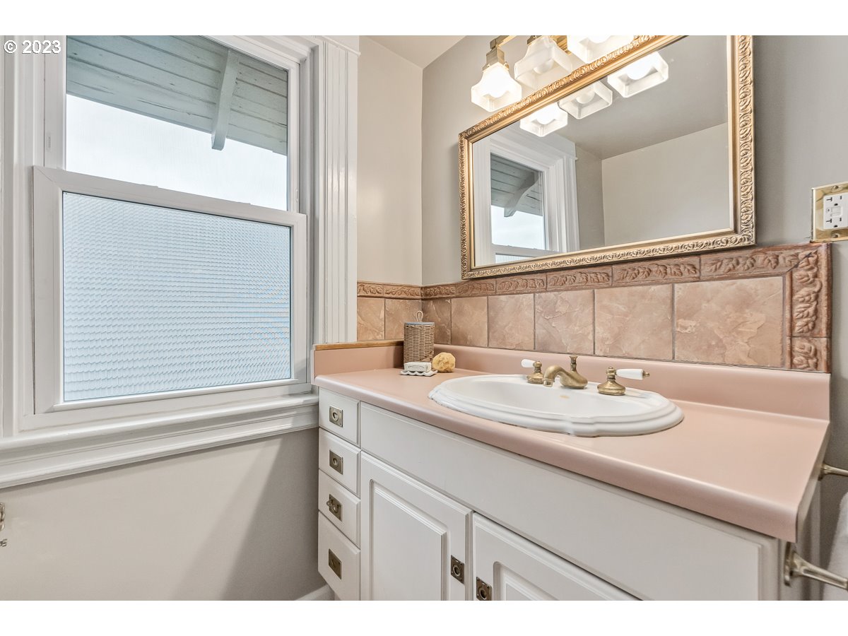 1410 Southeast 35th Avenue Portland, OR 97214 - Photo 23 of 39 a bathroom with a sink and a mirror