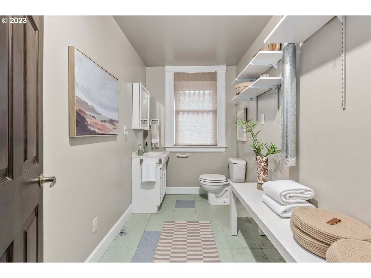 1410 Southeast 35th Avenue Portland, OR 97214 - Photo 29 of 39 a bathroom with a toilet a sink and a mirror