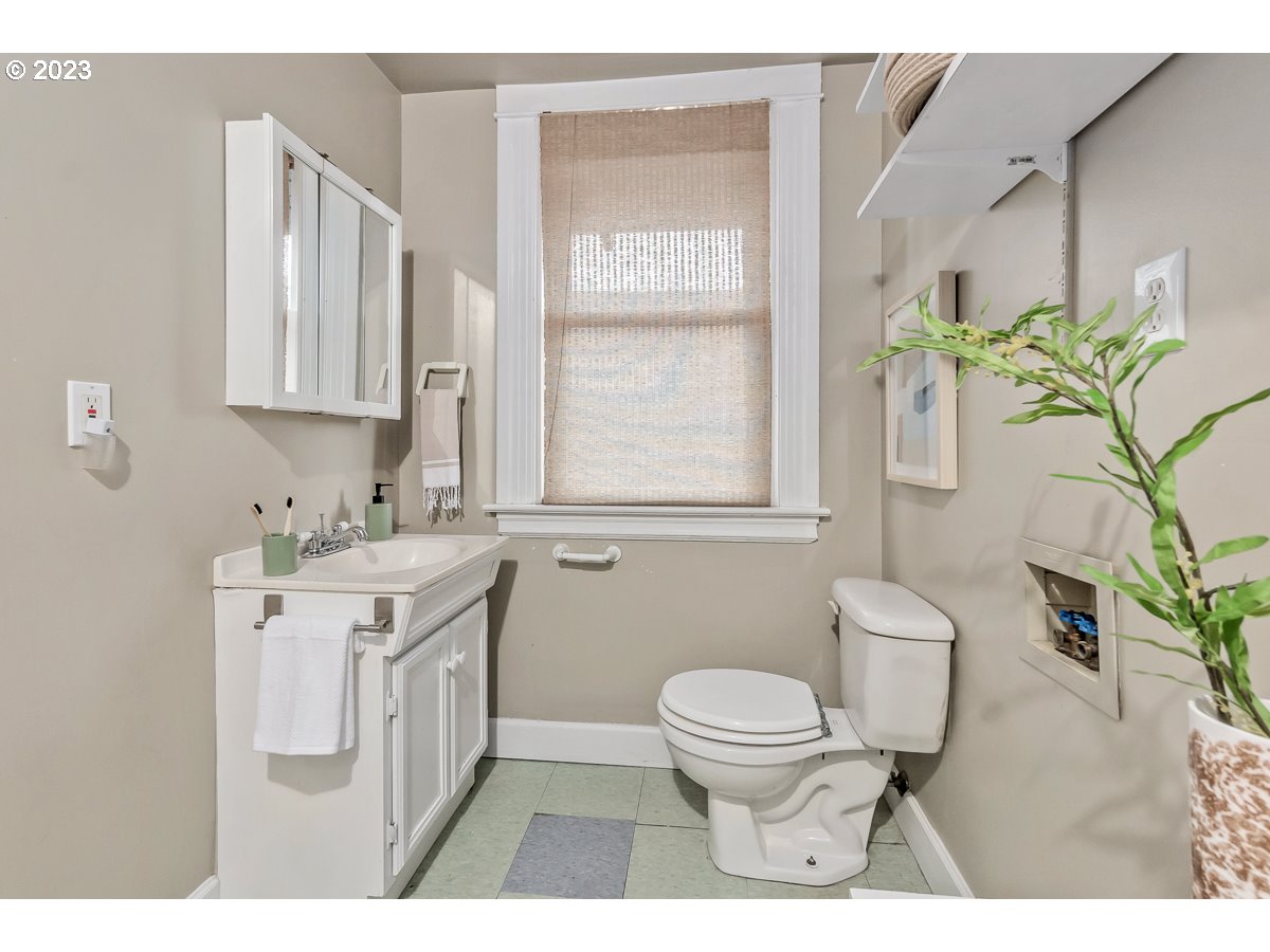 1410 Southeast 35th Avenue Portland, OR 97214 - Photo 30 of 39 a bathroom with a sink toilet and a mirror