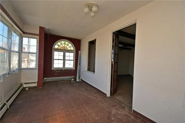 an empty room with windows and closet