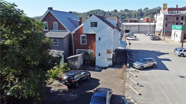 a view of a patio with couches table and chairs and potted plants
