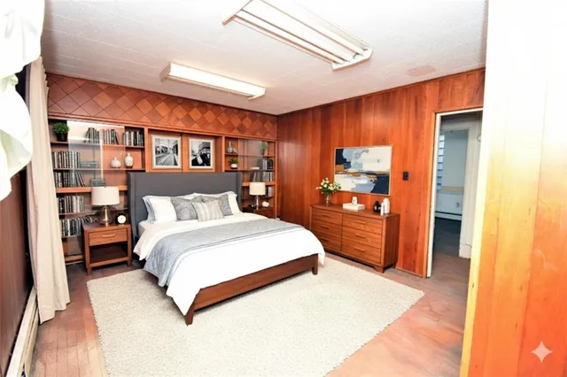 a bedroom with a large bed and a large mirror