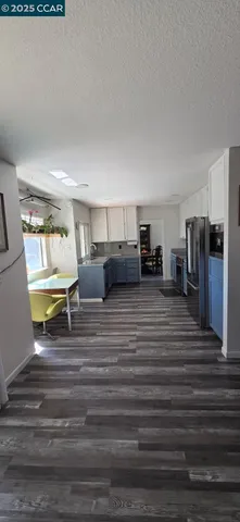 a kitchen with granite countertop a sink stove and refrigerator
