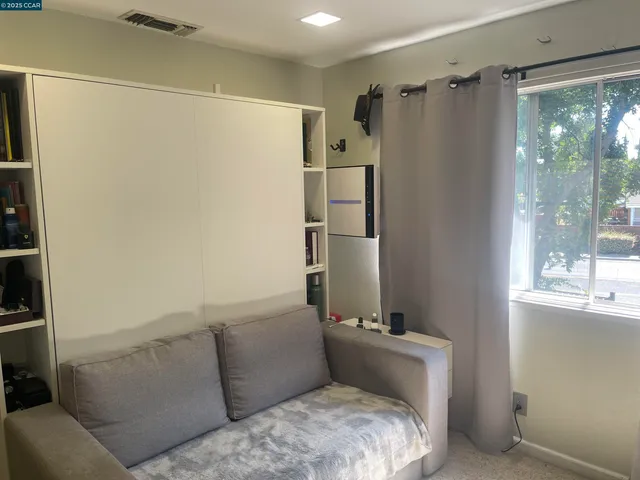 a view of a room with gym equipment and a window