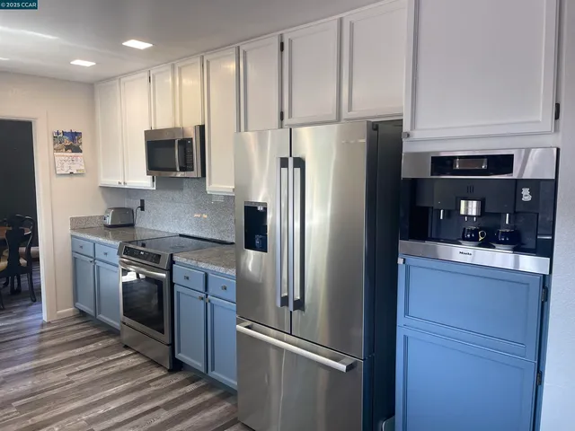a kitchen with a refrigerator and a stove