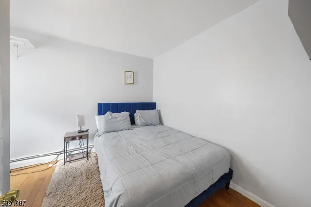 a large bed sitting in a bedroom next to a window