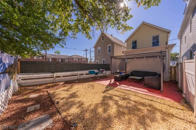 a view of a house with a yard and a fire pit