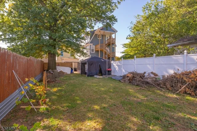 a backyard of a house with table and chairs