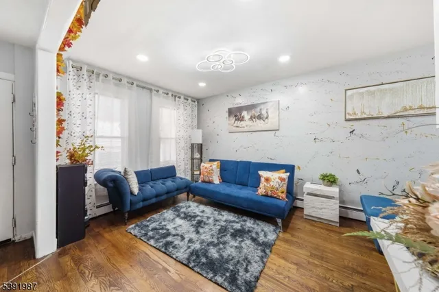 a living room with furniture and painting on the wall
