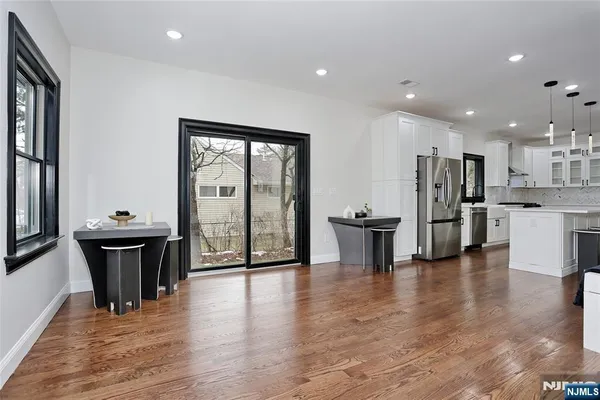 an open kitchen with white cabinets and stainless steel appliances