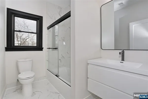 a bathroom with a toilet sink and shower