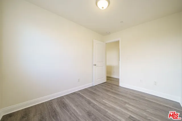 a view of an empty room and wooden floor