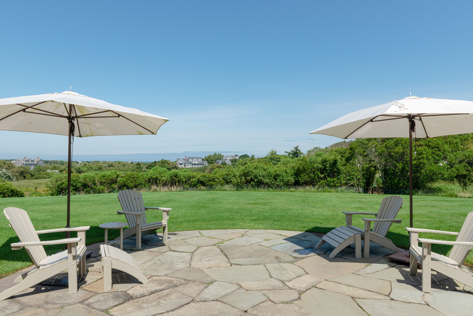 183 Polpis Road Nantucket, MA 02554 - Photo 41 of 62 a view of a chair and table in the garden
