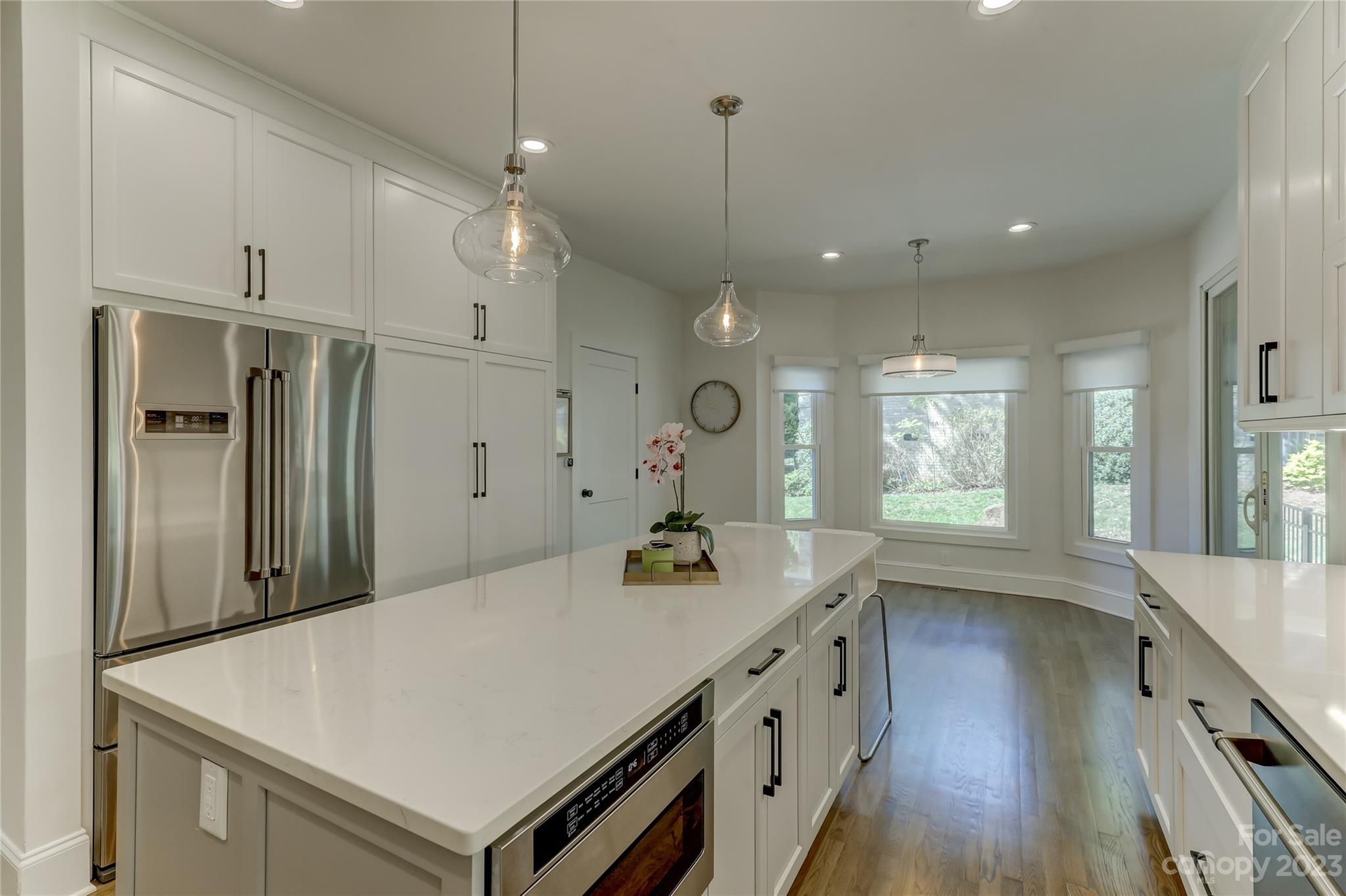 4308 Rosecliff Drive Charlotte, NC 28277 - Photo 15 of 39 a kitchen with a refrigerator a sink and wooden floor