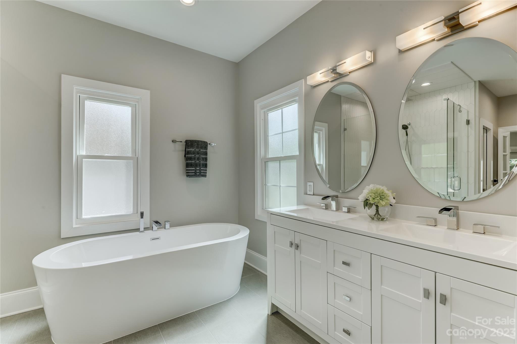 4308 Rosecliff Drive Charlotte, NC 28277 - Photo 24 of 39 a bathroom with a double vanity sink mirror double and bathtub