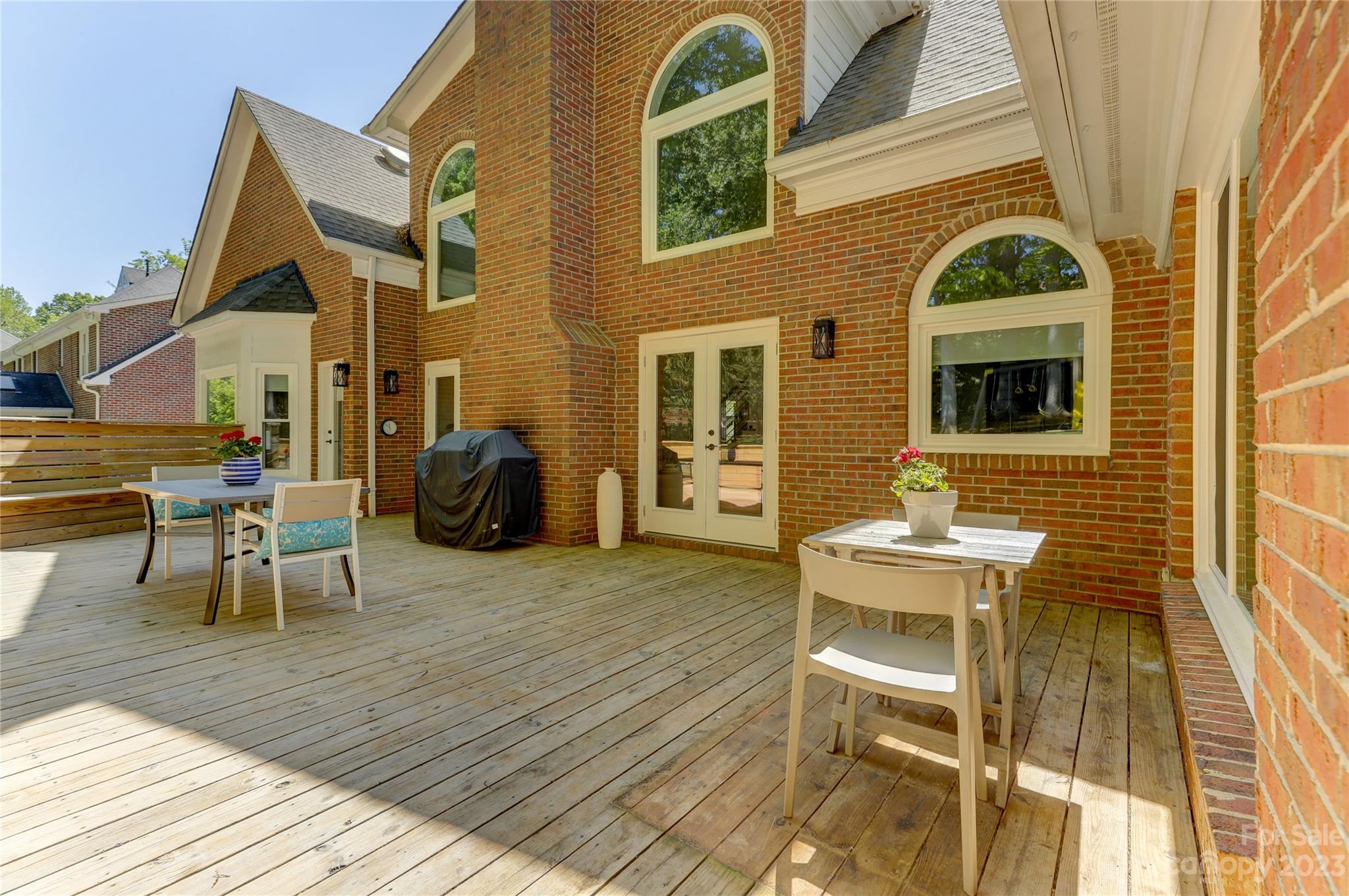 4308 Rosecliff Drive Charlotte, NC 28277 - Photo 37 of 39 a view of a brick house with a chairs and table in a patio