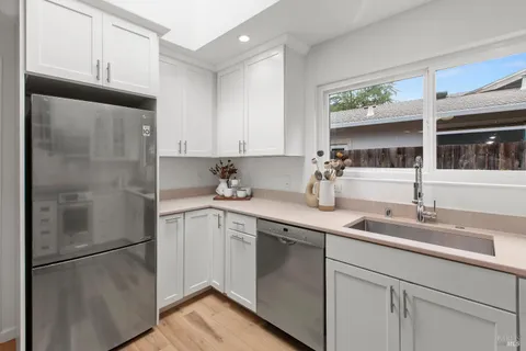a kitchen with stainless steel appliances a stove microwave and cabinets