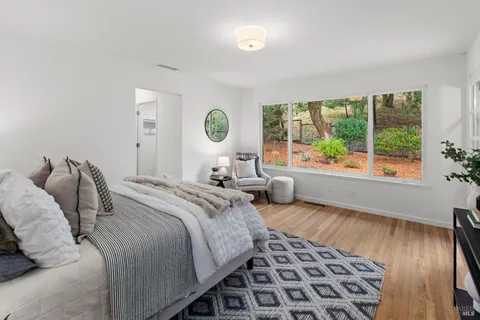 a bedroom with a bed and a mirror