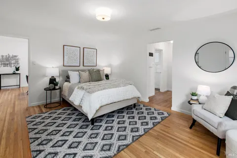 a bedroom with a bed and large windows