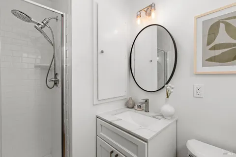 a bathroom with a sink mirror and toilet