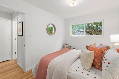 a bedroom with a bed and a lamp on dresser