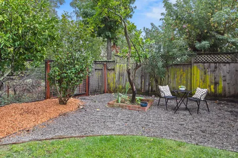a view of a backyard with sitting area furniture and garden