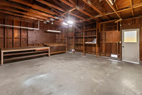 a view of a house with a yard and a tree