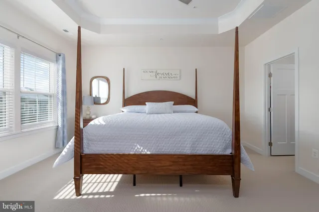 a bed sitting in a bedroom next to a window