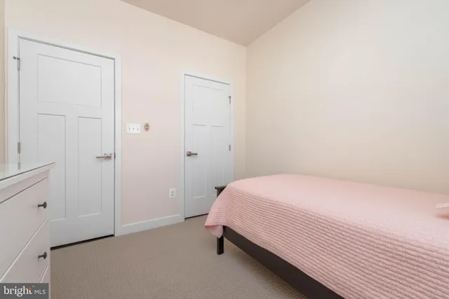 a bedroom with a bed and a closet