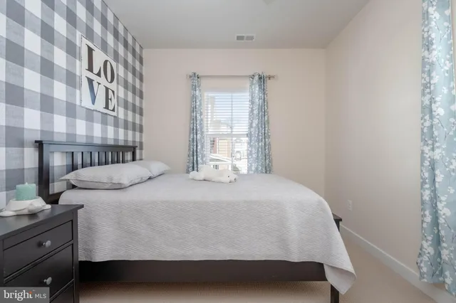 a bedroom with a bed and a lamp