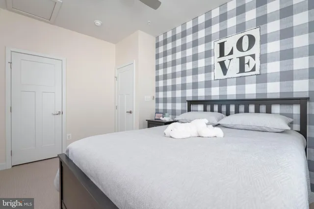 a bedroom with a bed and a painting on the wall