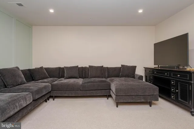 a living room with couches and a flat screen tv