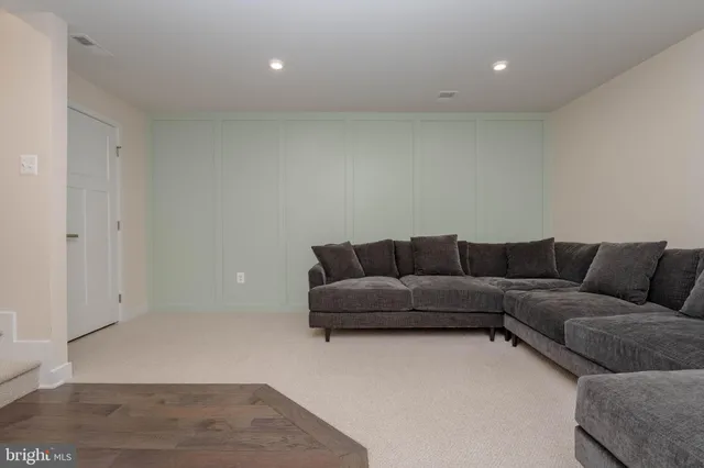 a living room with a couch and a rug