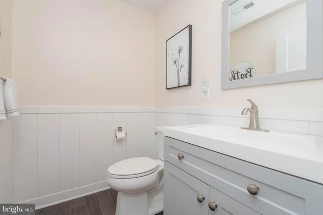 a bathroom with a toilet a sink and mirror