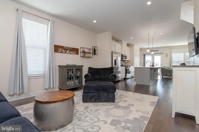 a living room with furniture and kitchen view