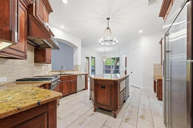 a living room with furniture flowerpot and wooden floor