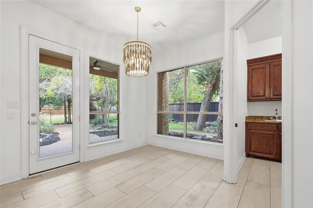a kitchen with granite countertop stainless steel appliances a sink stove and cabinets